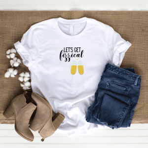 white tshirt displayed on a wooden background with boots and jeans with the graphic let's get fzzical