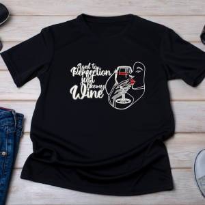 Black t-shirt on displayed on a wooden background with the graphic aged to perfection just like my wine