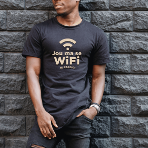 Male leaning against a wall with a graphic tee your ma se wifi is stag
