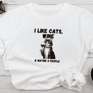 Graphic tee with a cat drinking wine with statement i like cats, wine and maybe 3 people displayed