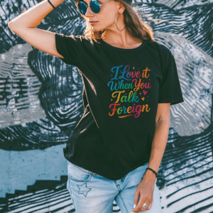 Female wearing a rainbow glitter graphic tee