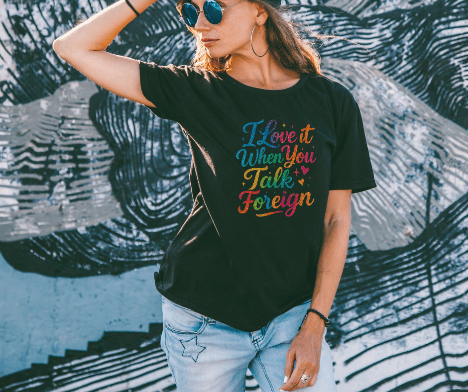 Female wearing a rainbow glitter graphic tee